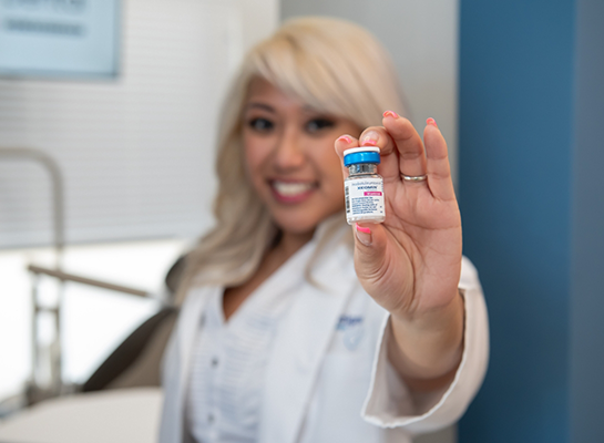 Doctor Nina Cecilia Santos holding a vial of Botox