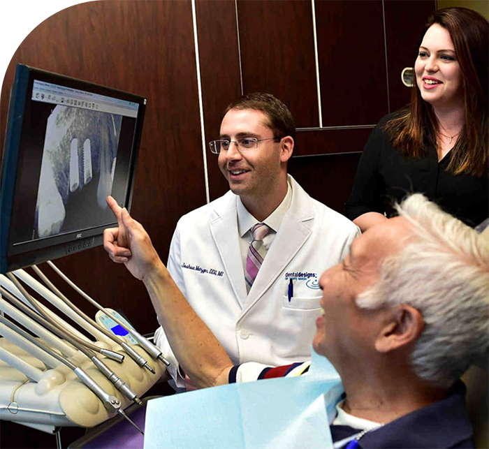 Man looking at x rays of his teeth with his cosmetic dentist in Hanover