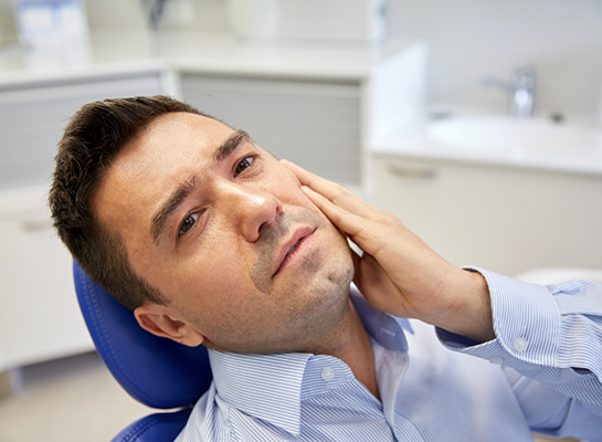 Hanover emergency dentist smiling outside of dental treatment room