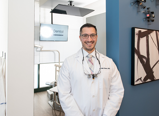 Hanover dentist smiling outside of dental exam room