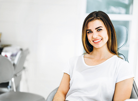 Young woman grinning in dental chair