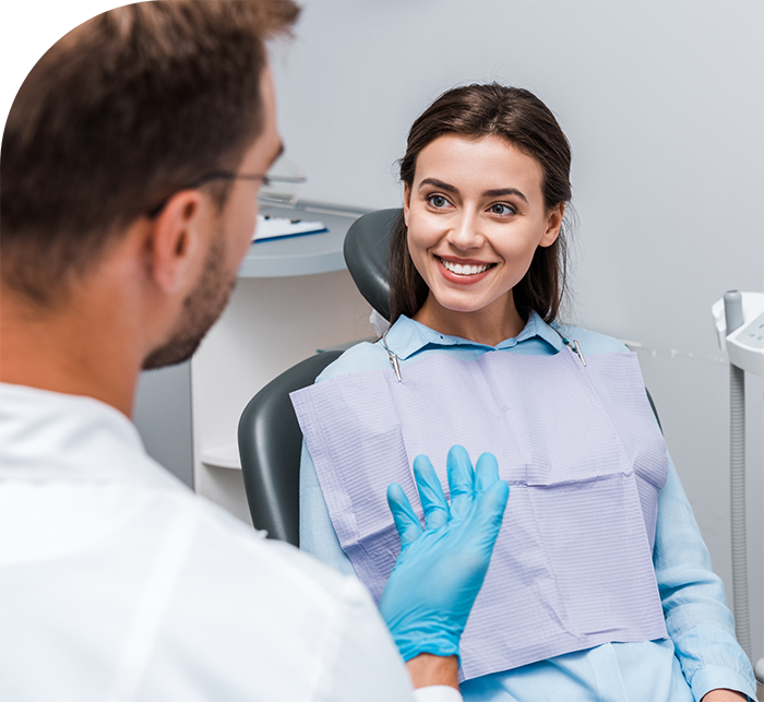 Woman in dental chair smiling at her Hanover dentist