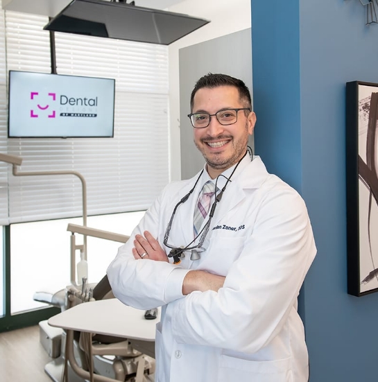 Hanover dentist smiling and standing with arms crossed