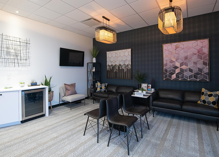 Black chairs and loveseats in reception area of dental office in Hanover