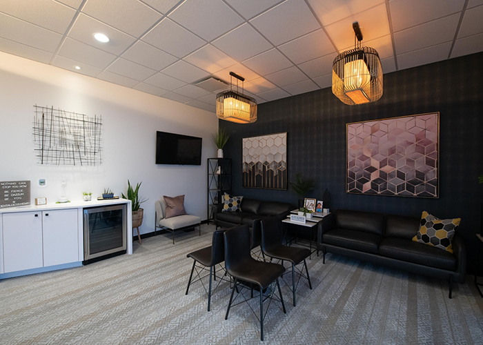 Black chairs and loveseats in reception area