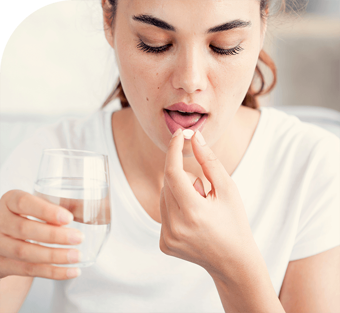 Woman about to take a pill