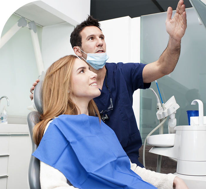 Dentist showing a patient a screen after restorative dentistry in Hanover