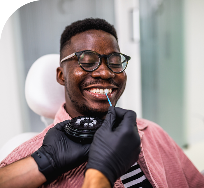 Smiling man being fitted for veneers by Hanover cosmetic dentist